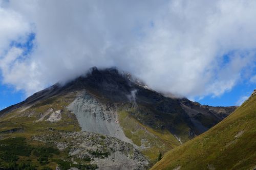 Free Cloud-covered mountain peak in Karyntia, Austria under a clear sky with lush greenery. Stock Photo