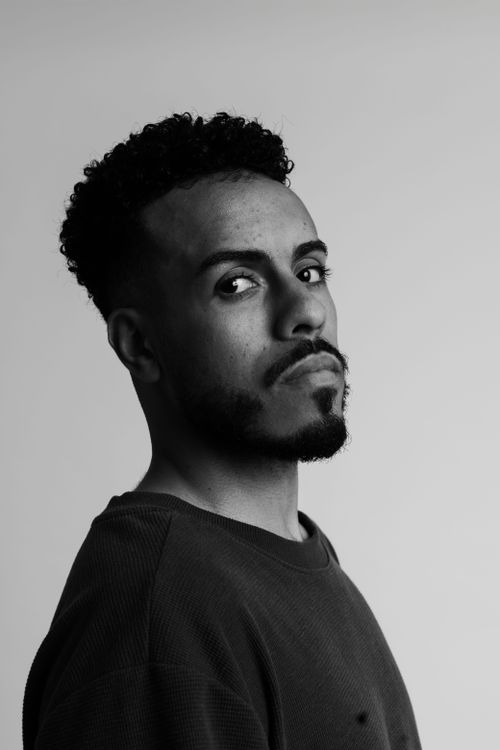 Free Moody black and white portrait of a man gazing introspectively, evoking contemplation. Stock Photo