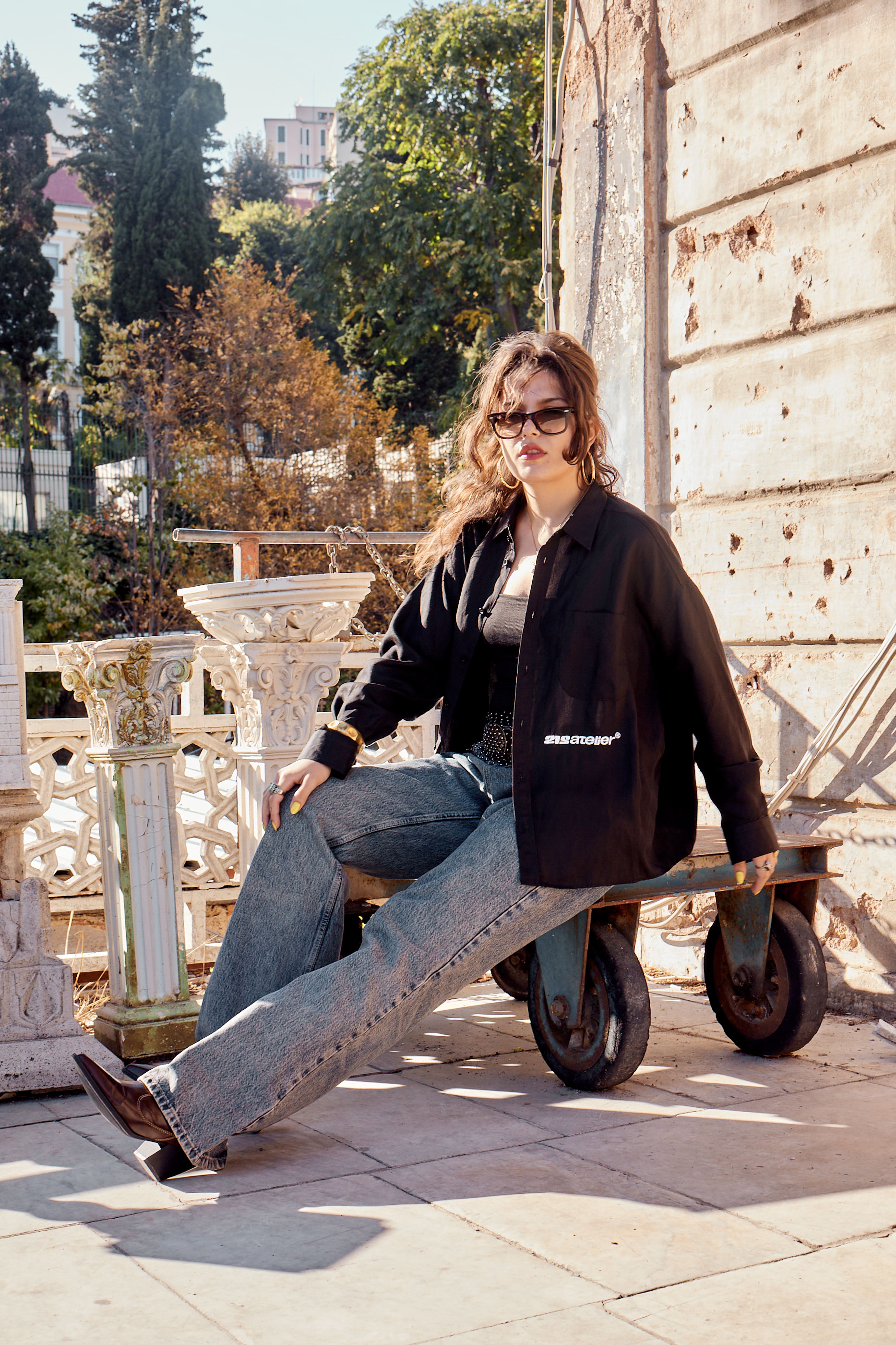 Young woman posing outdoors in Istanbul with vintage fashion style.