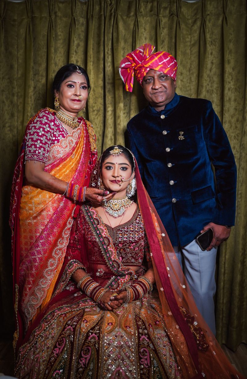 Bride with her parents in traditional Indian attire