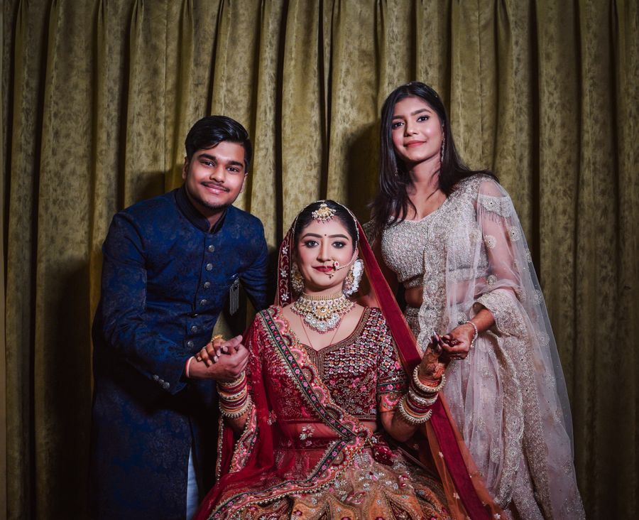 Traditional Indian wedding portrait with bride and guests