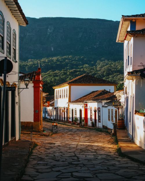 Free Cobblestone street lined with colorful colonial buildings in a picturesque historical town. Stock Photo