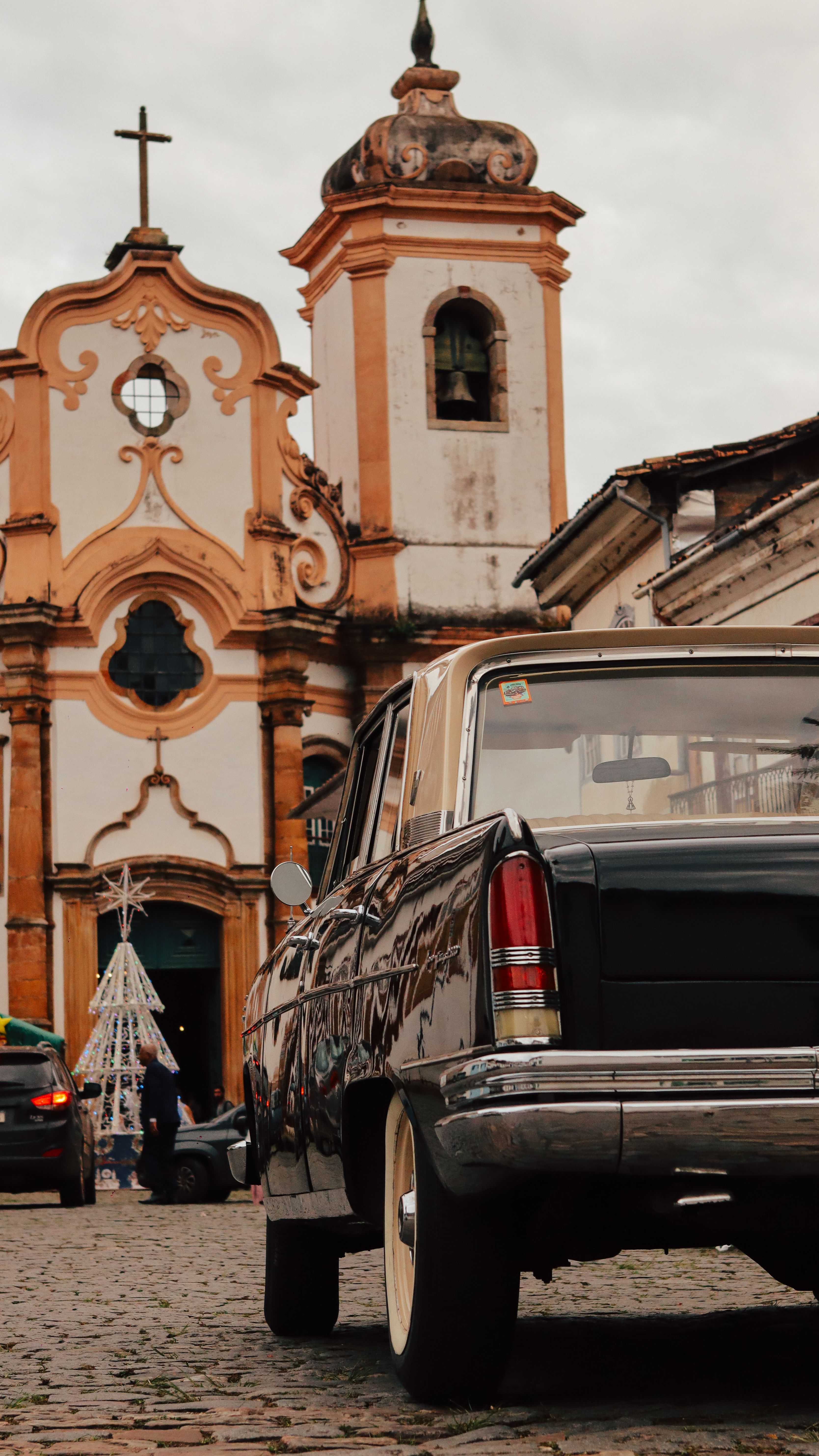 Vintage Car in Front of Historic Church Facade · Free Stock Photo