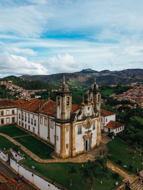 Free Stunning aerial view of a historic church in Ouro Preto, Brazil, with scenic mountain backdrop. Stock Photo