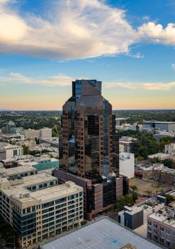 Aerial view of Sacramento's skyline, highlighting a prominent modern building at sunset.