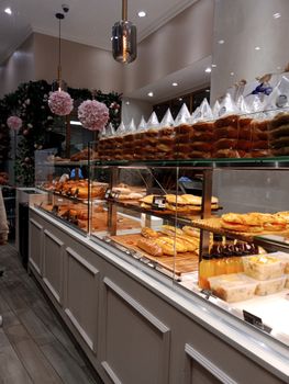 A beautiful indoor patisserie in France with diverse pastries on display.