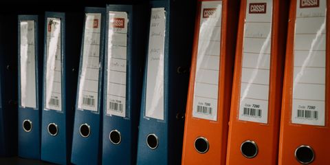 Row of colorful office binders neatly arranged on a shelf, ideal for organization concepts.