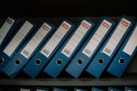 Organized Blue Office Binders on Shelf