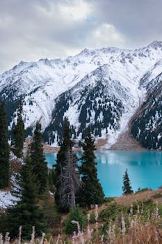 Stunning view of snowcapped mountains and turquoise Big Almaty Lake.