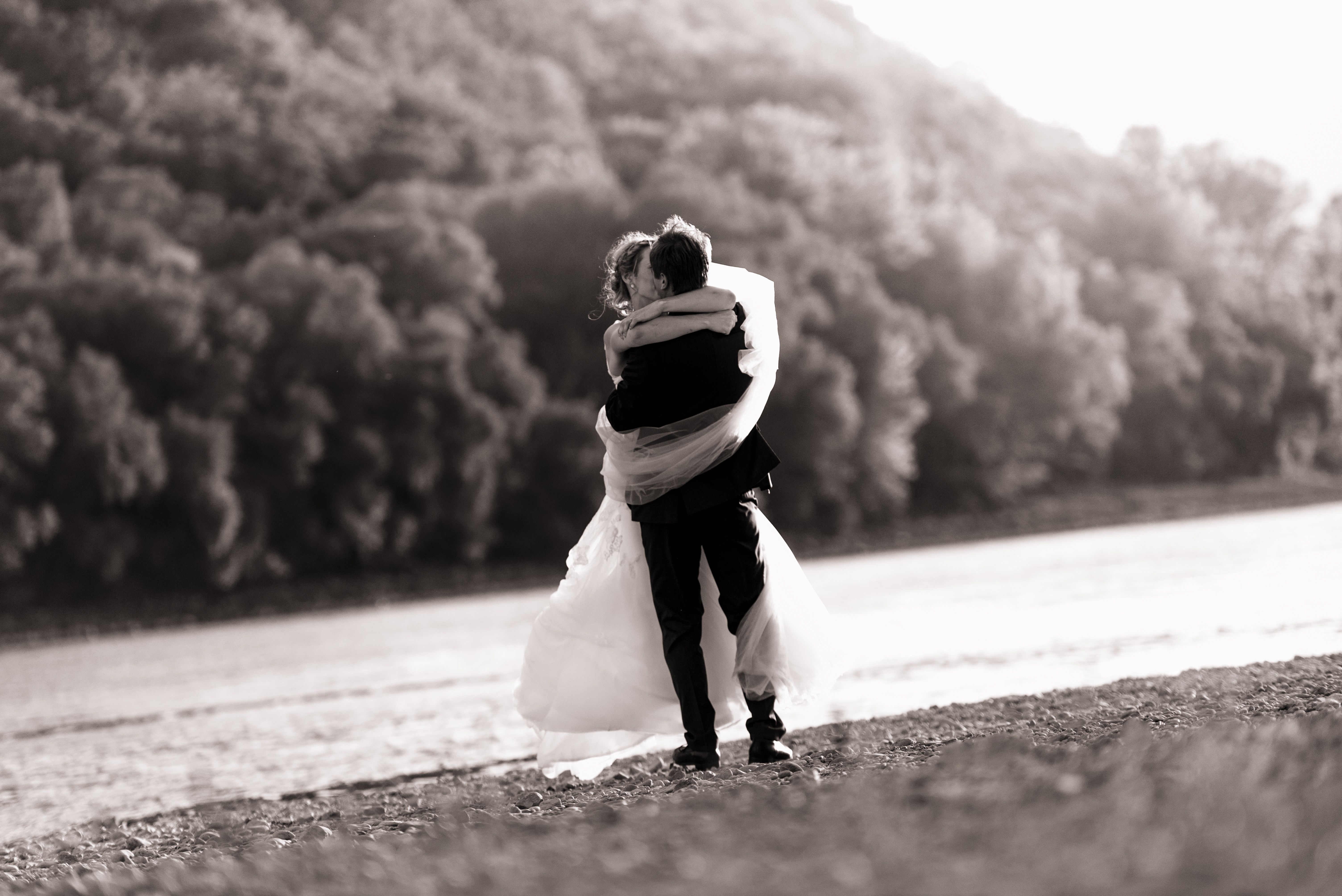 Romantic Wedding Couple Embracing Outdoors · Free Stock Photo
