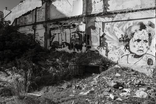 Free Black and white photo of urban decay with graffiti on abandoned building, vibrant street art scene. Stock Photo