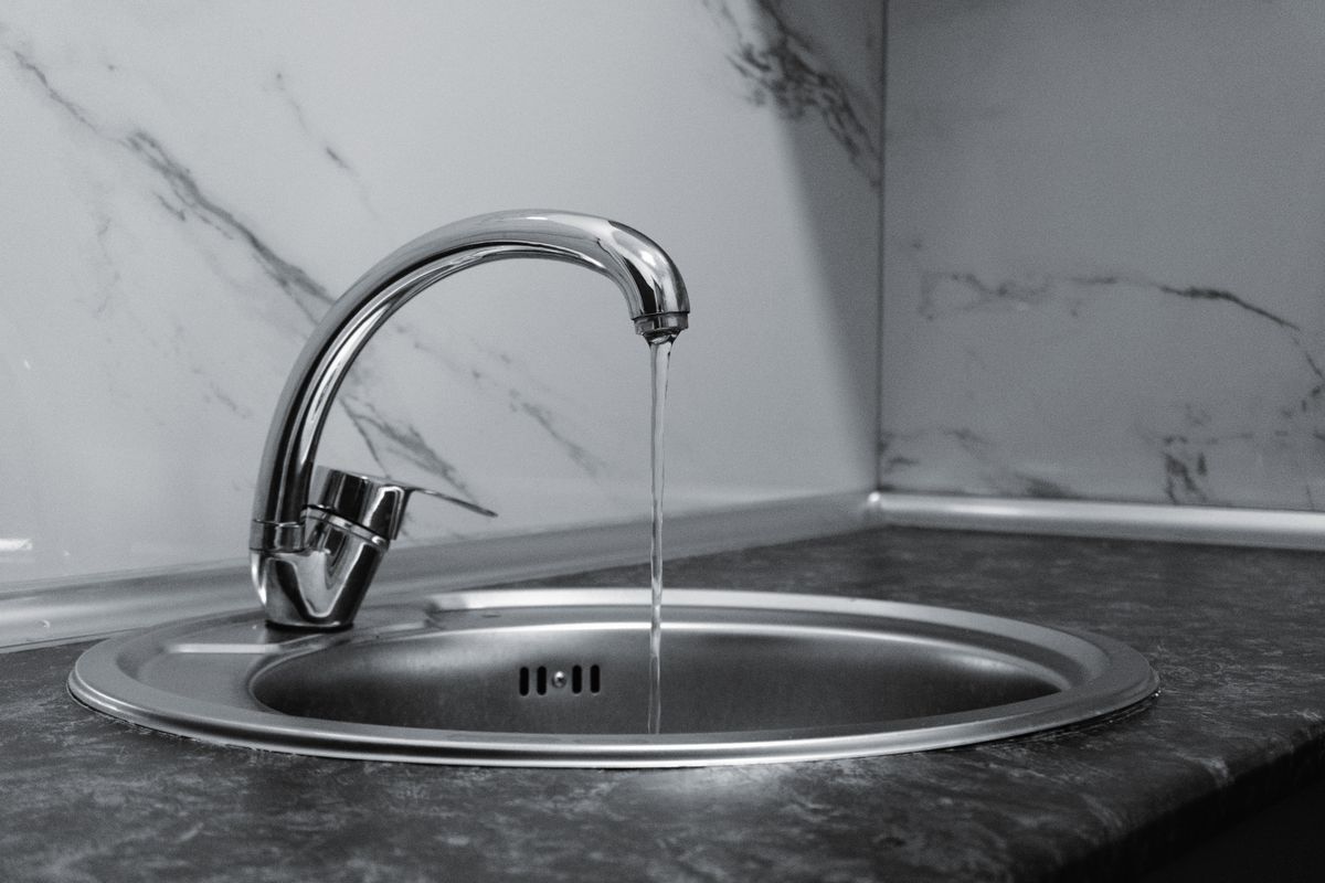 Modern chrome kitchen faucet with running water