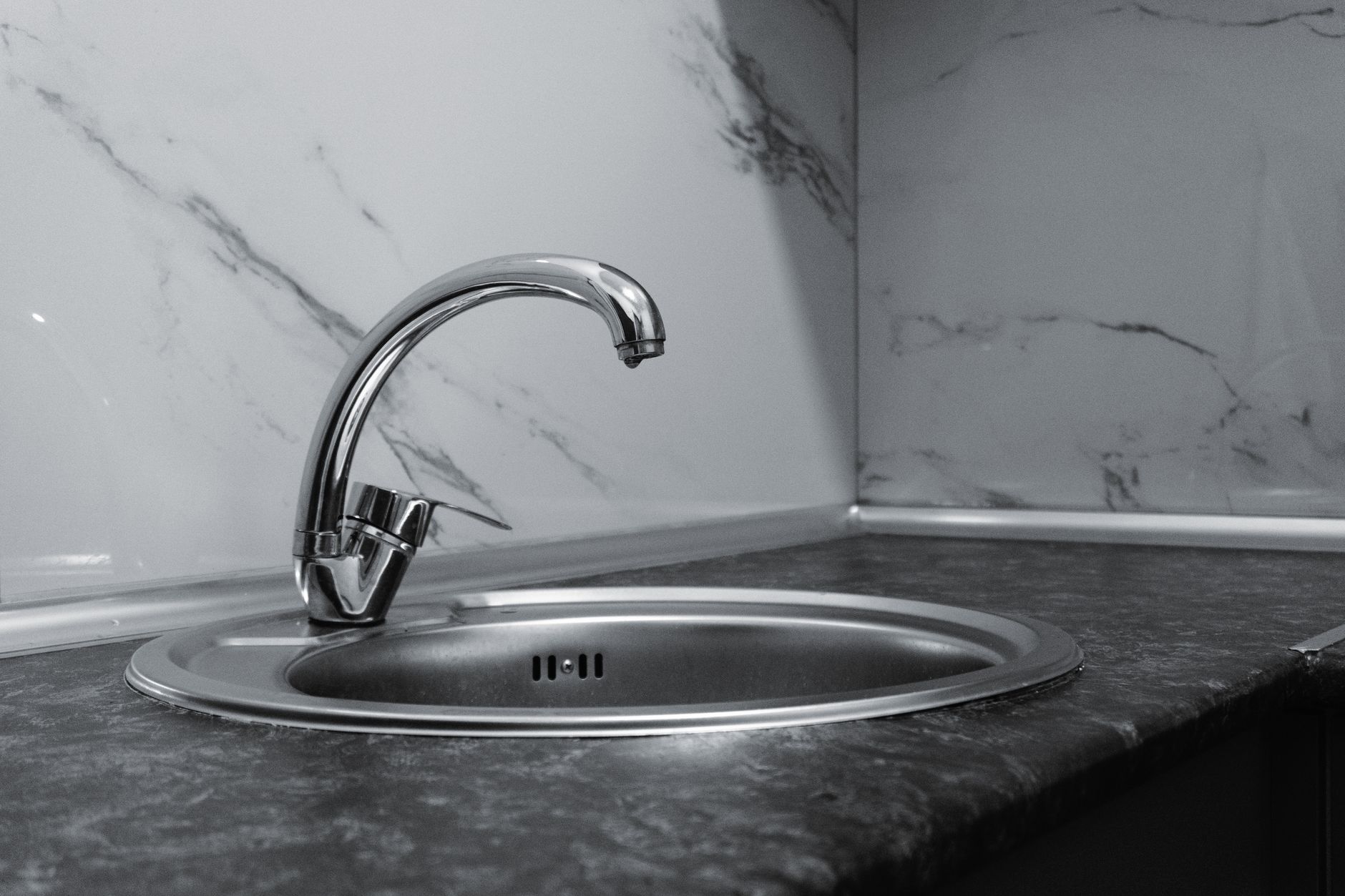 Sleek stainless steel sink and faucet in a contemporary kitchen setting.