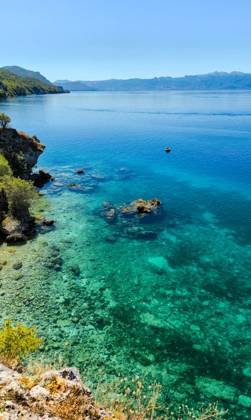 Free Vibrant turquoise waters of Ohrid's serene coastline from an aerial perspective, perfect for travel enthusiasts. Stock Photo