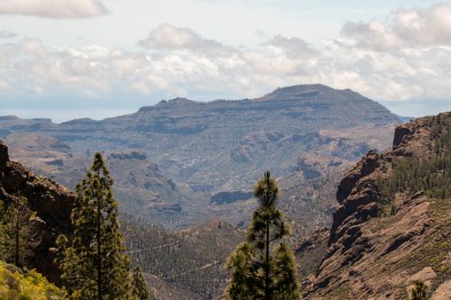 Free Breathtaking view of mountains and forests in Gran Canaria under a partly cloudy sky. Stock Photo