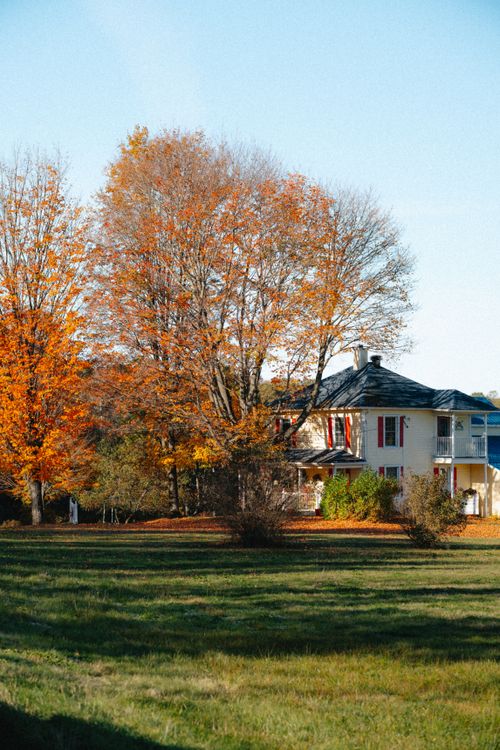 Free Beautiful fall foliage surrounds a quaint house in North Hatley, Québec. Stock Photo