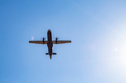 Free A dramatic view of an airplane flying overhead against a clear blue sky in Londrina, Brazil. Stock Photo