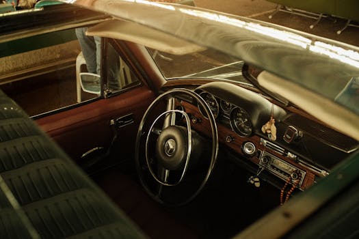 Interior view of a vintage car showing its classic design and elegant steering wheel.