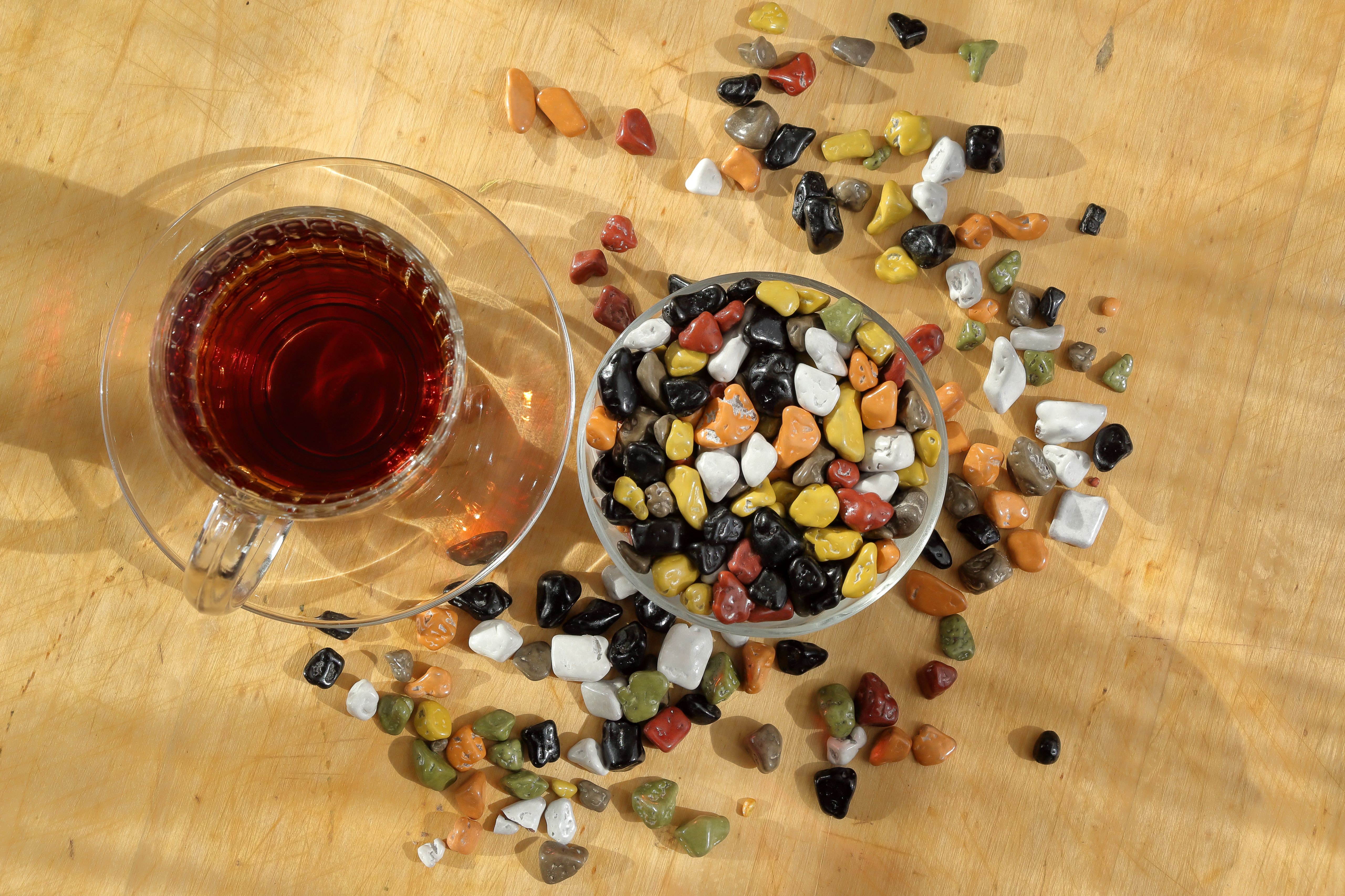 Colorful Pebbles and Tea on Wooden Surface · Free Stock Photo