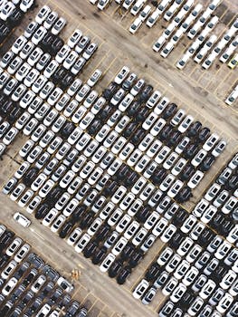 Aerial perspective of a large car parking lot showcasing aligned vehicles in Brazil.
