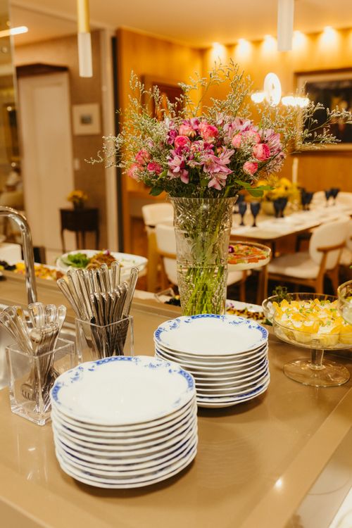 Free Beautiful dining area with floral centerpiece and elegant dinnerware on display. Stock Photo
