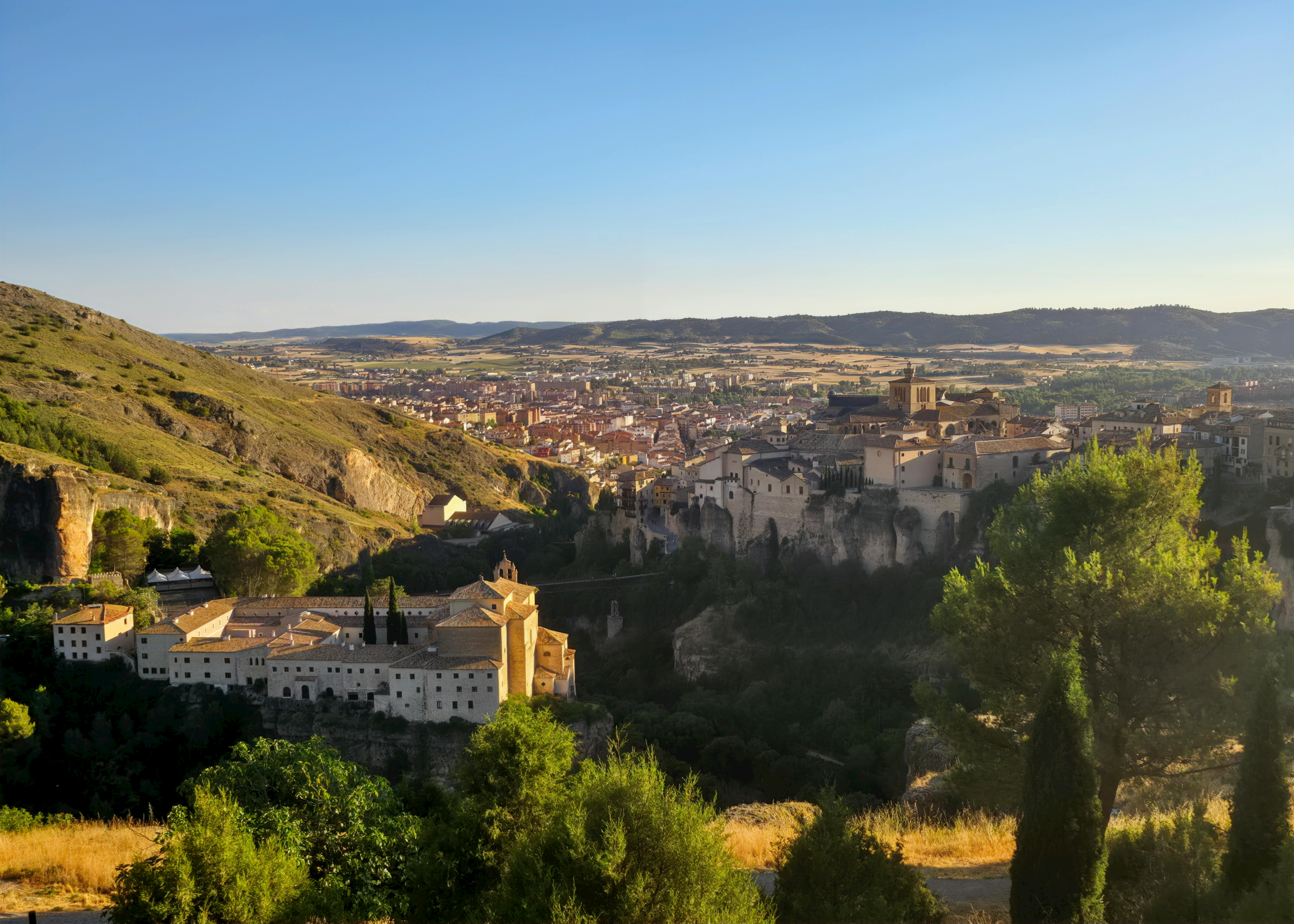 Captivating sunset view of Cuenca, Spain, showcasing historic architecture and natural beauty. - Cuenca