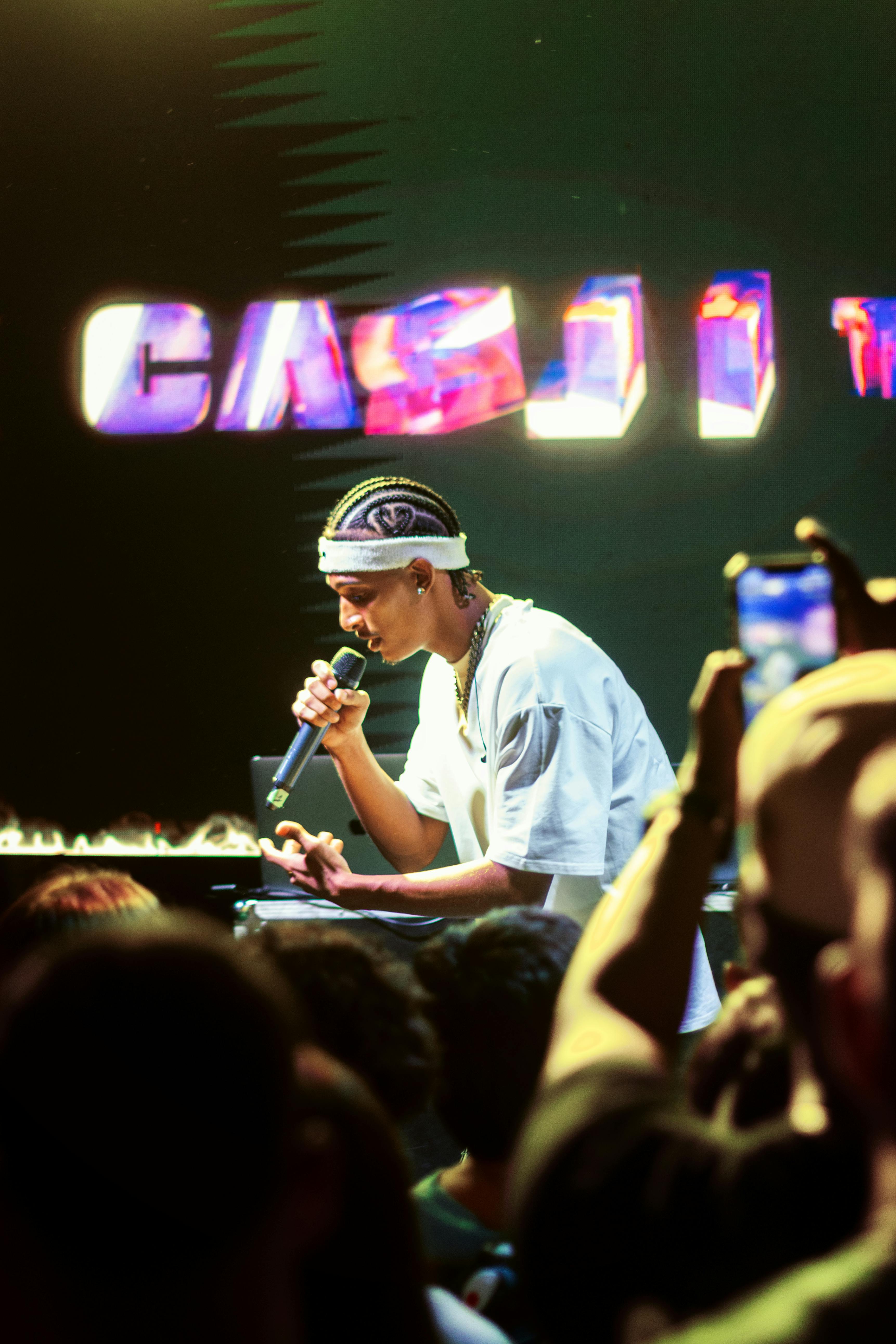 A young artist captivates the crowd during a lively stage performance.