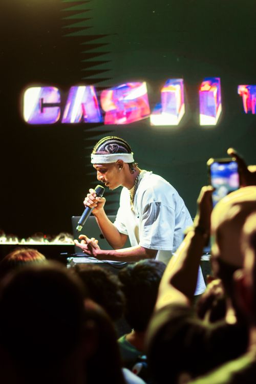 Free A young artist captivates the crowd during a lively stage performance. Stock Photo