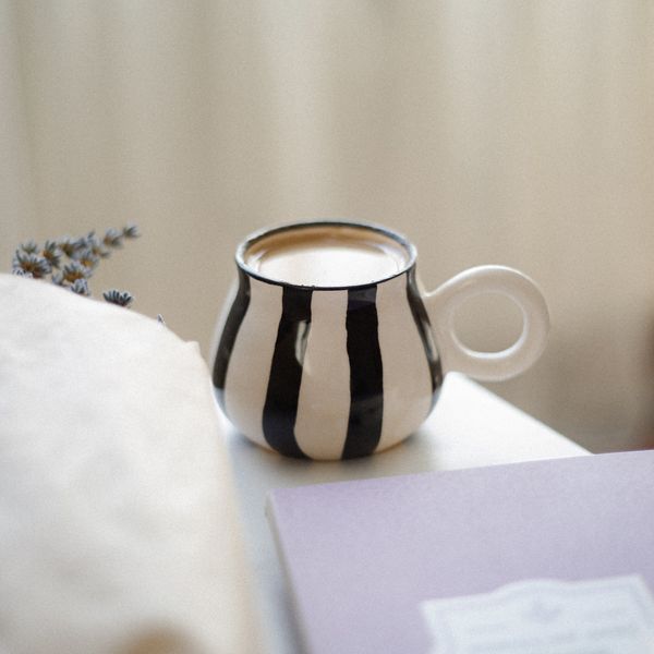Striped ceramic mug by betül nur akyürek on Pexels