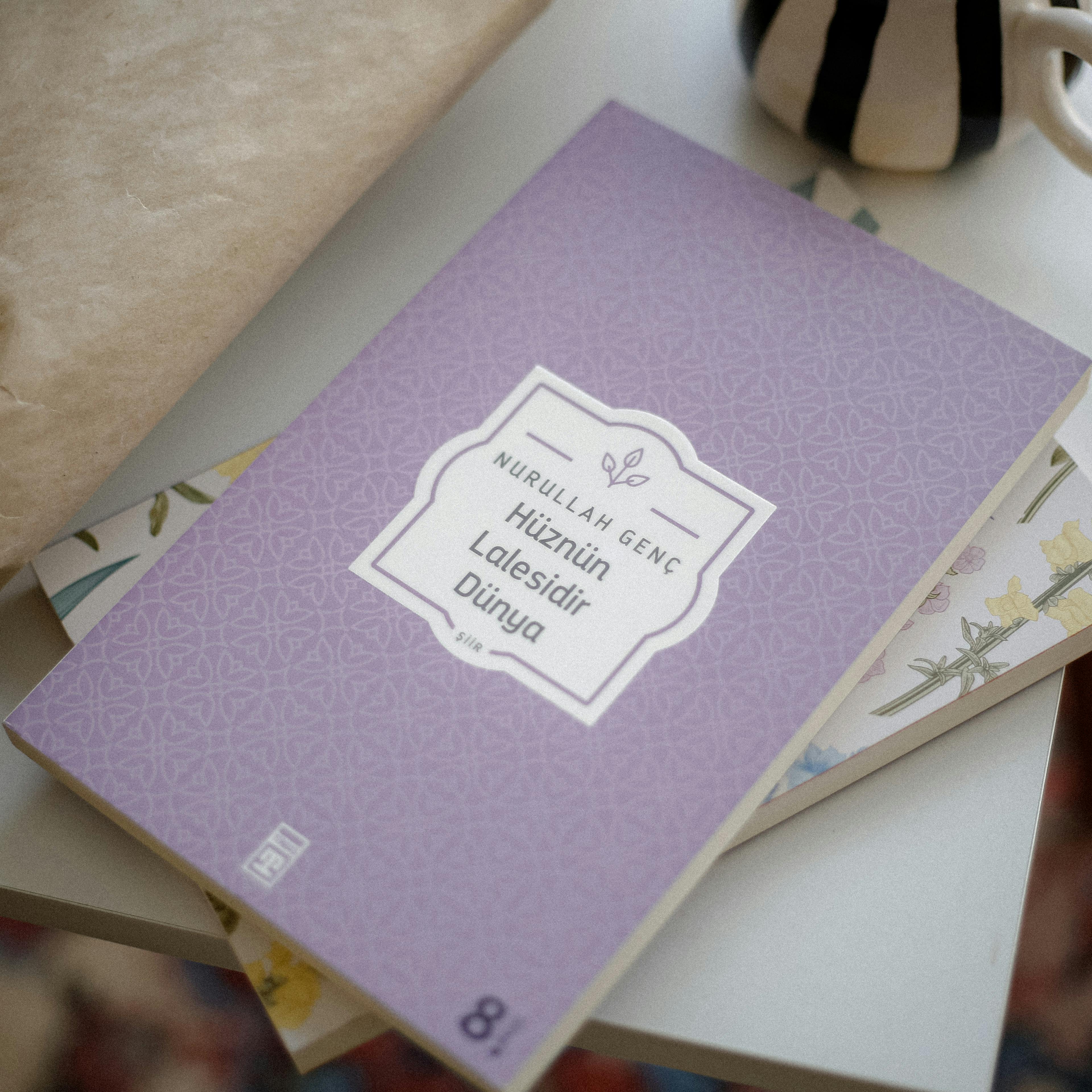 A peaceful indoor setup featuring a poetry book and a cup on a table.