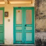 Teal front door on a textured wall, photo by Aysegul Aytoren on Pexels