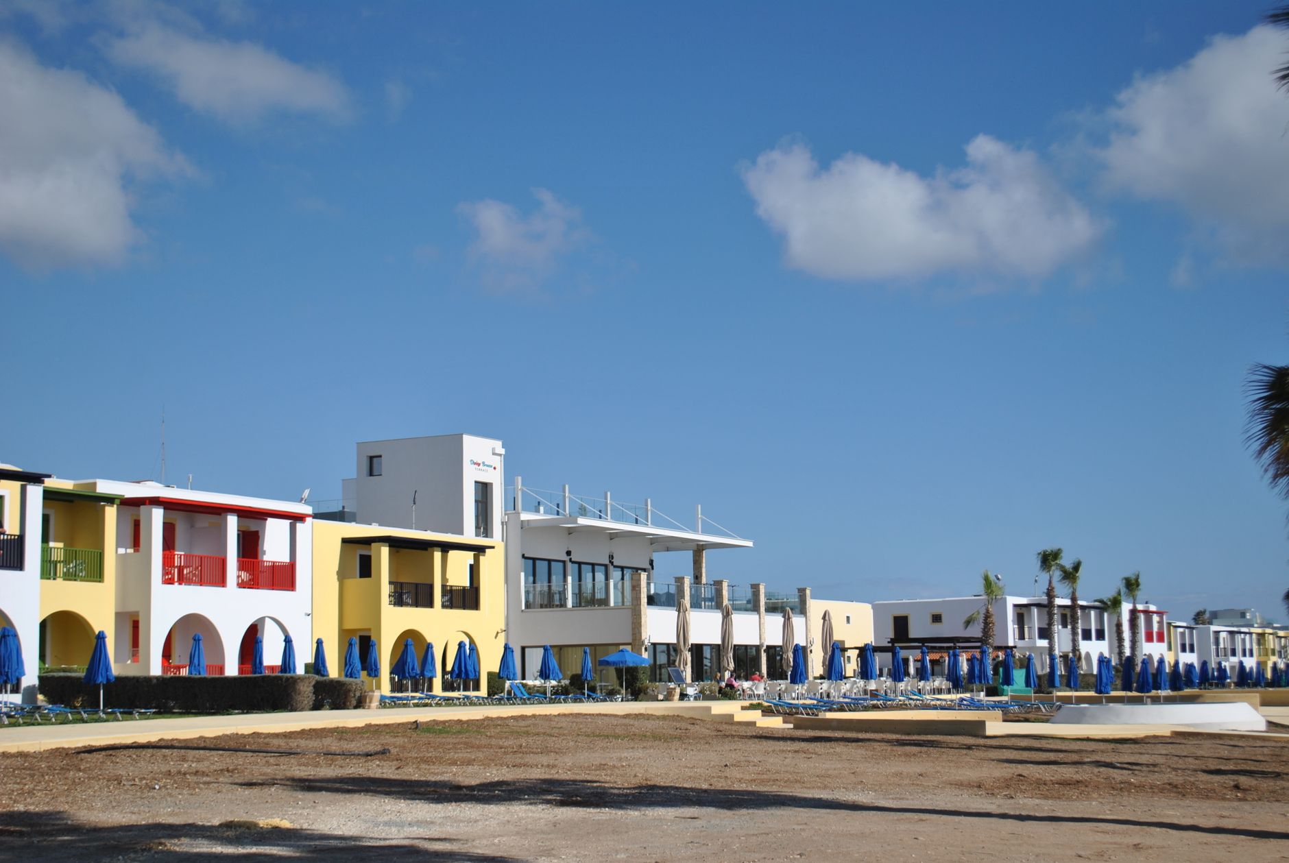 Beachfront hotel area with colorful buildings and umbrellas along the Gulf Coast
