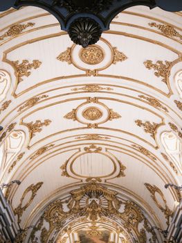 View of an opulent interior ceiling in Rio de Janeiro with intricate gold details.