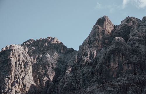 Free Dramatic view of rugged mountain peaks under a clear blue sky, showcasing impressive natural formations. Stock Photo