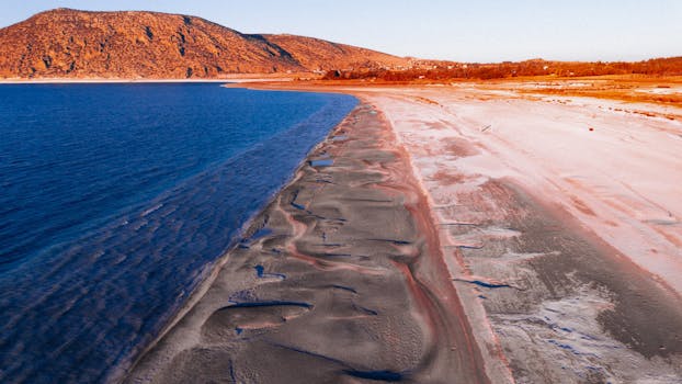 A breathtaking aerial view of Salda Lake with vibrant colors during golden hour.