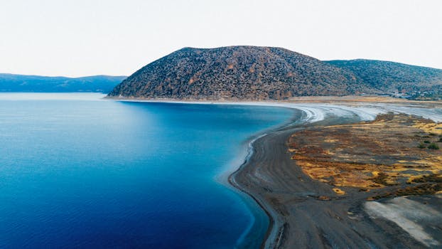 Aerial view of Salda Lake with its clear blue waters and mountainous background in Burdur, Turkey.