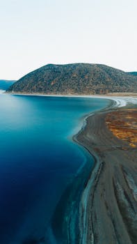 Stunning aerial view of Salda Lake with its turquoise waters and rugged mountainous landscape.