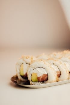 Appetizing sushi rolls with creamy filling served on a sleek plate, ideal for culinary themes.