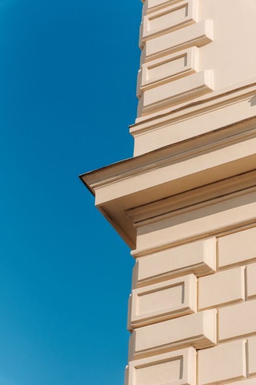 Free Detail of an ornate building facade in Vienna, Austria, under a clear blue sky. Stock Photo