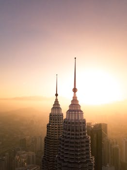 Stunning aerial view of the Petronas Towers at sunset in Kuala Lumpur, Malaysia.