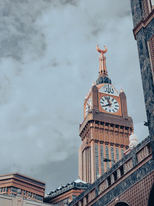 Free Stunning upward view of the iconic Makkah Clock Tower against a cloudy sky, symbolizing spiritual significance. Stock Photo