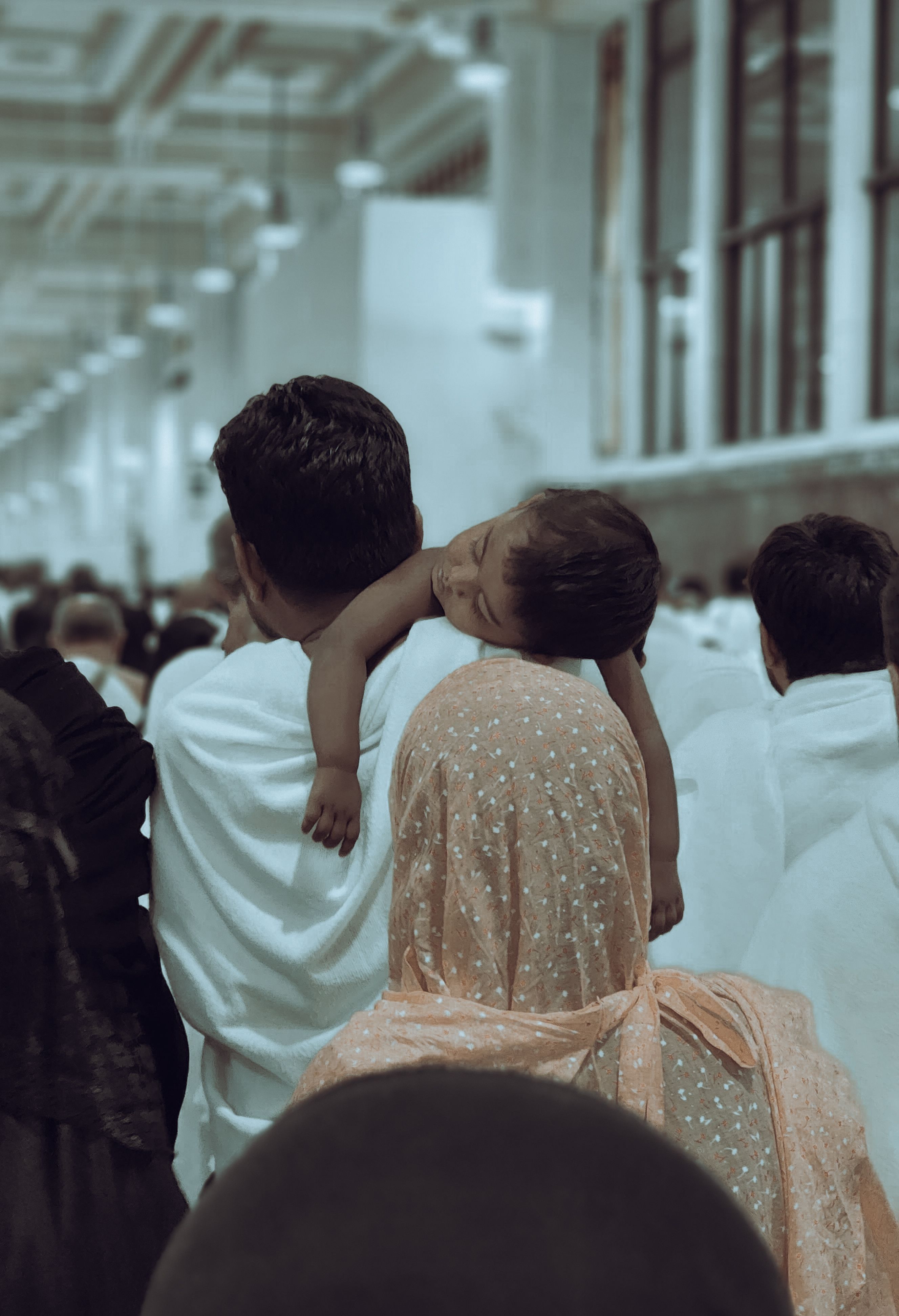 Touching scene of a family visiting the holy site of Masjid al-Haram, a place of faith and spirituality.