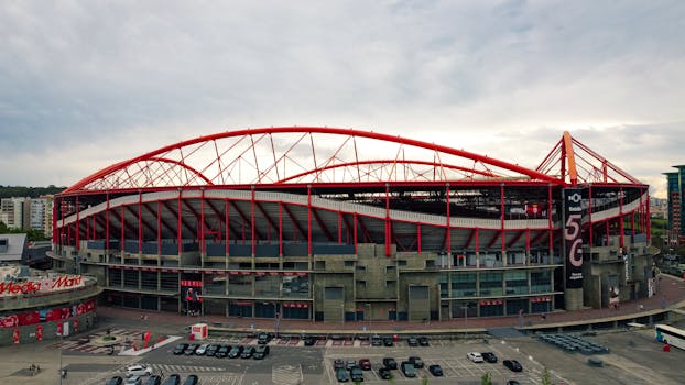 Aerial shot of the iconic Estádio da Luz in Lisbon, known for its striking red arches and modern architecture.