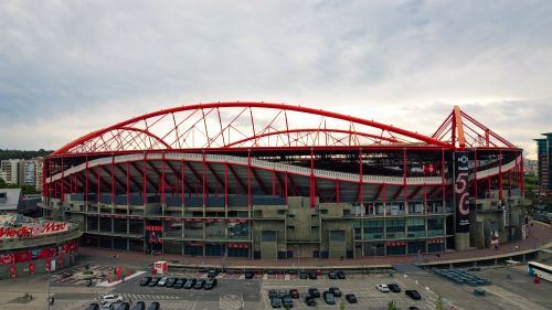 Free Aerial shot of the iconic Estádio da Luz in Lisbon, known for its striking red arches and modern architecture. Stock Photo