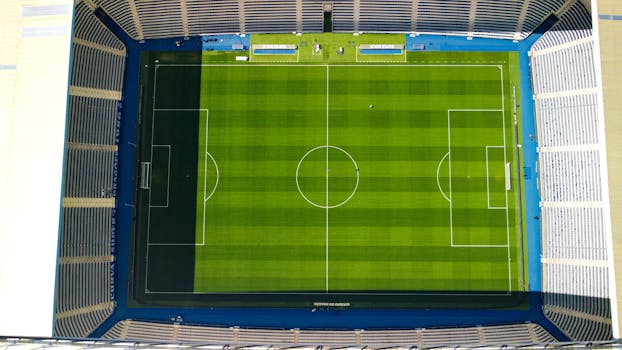 Aerial shot of Estádio do Dragão's green pitch, showcasing its expansive seating and iconic design.