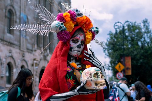 Free A colorful Día de los Muertos celebration in Mexico City with traditional Catrina costume and skull makeup. Stock Photo