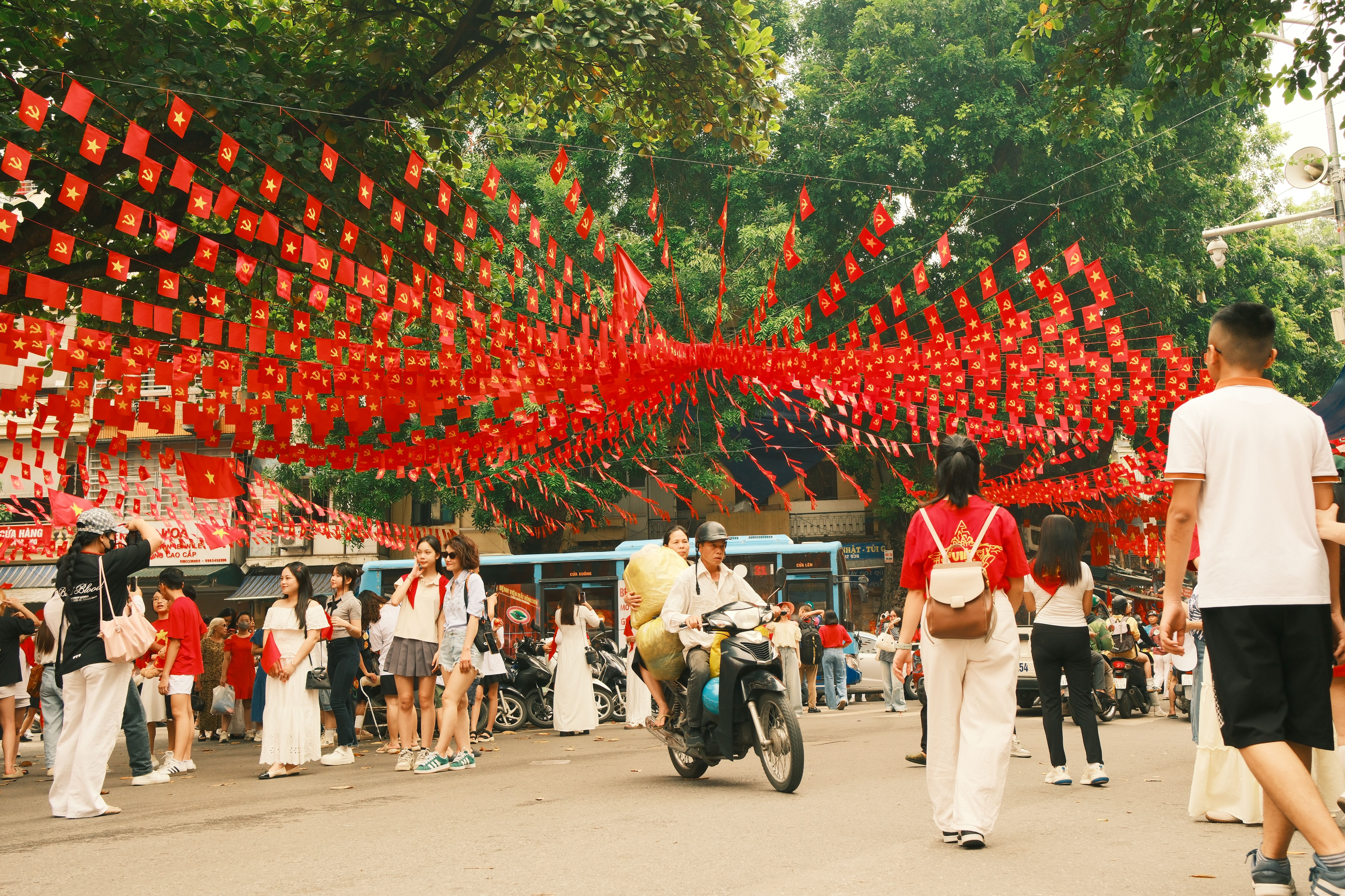 Vibrant Street Celebration with Red Flags · Free Stock Photo