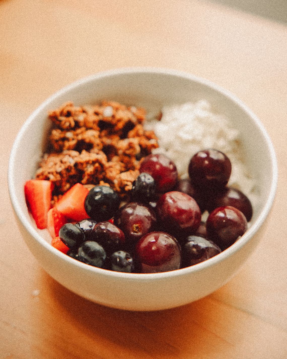 Real fruit and granola bowl photographed from above