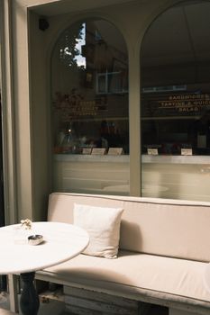 Elegant cafe setting with outdoor seating, offering a warm and inviting atmosphere for relaxation.