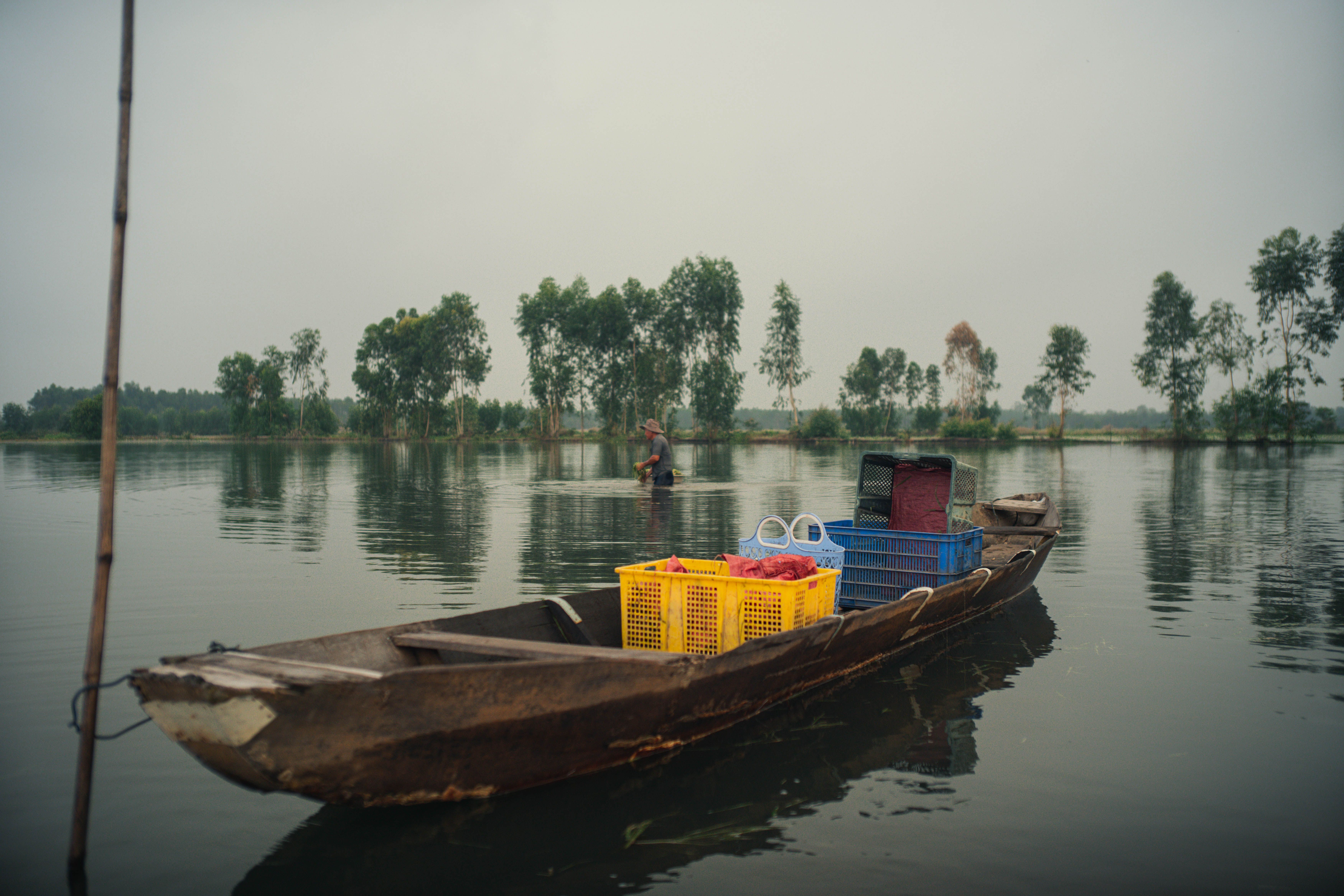 Rustic Wooden Boat on Serene Lake Waters · Free Stock Photo